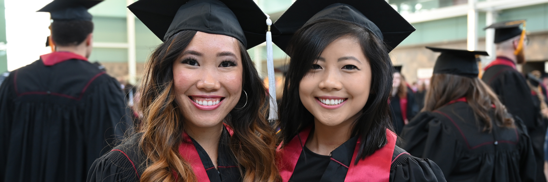 Two female graduates standing