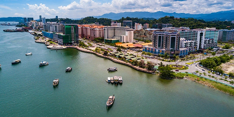 Overhead view of the Kota Kinabalu skyline and boats in the water